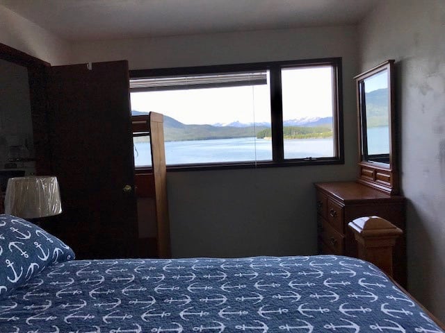Room with double bed and view of ocean