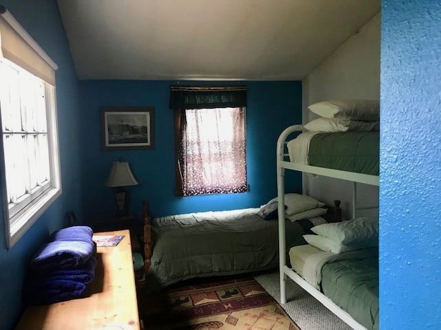Room with a single bed, bunk beds and dresser